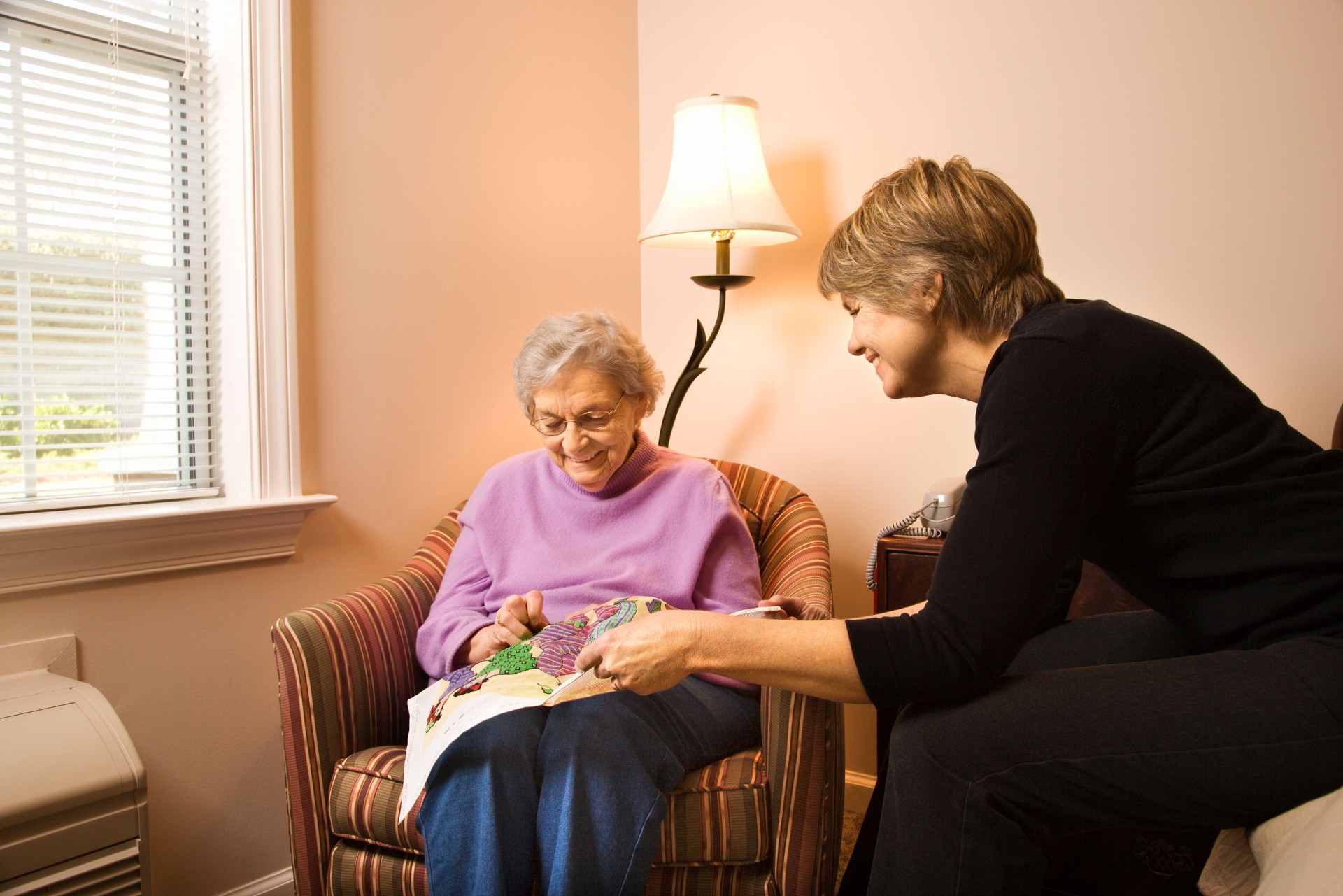 Senior Doing Needlepoint With Younger Woman